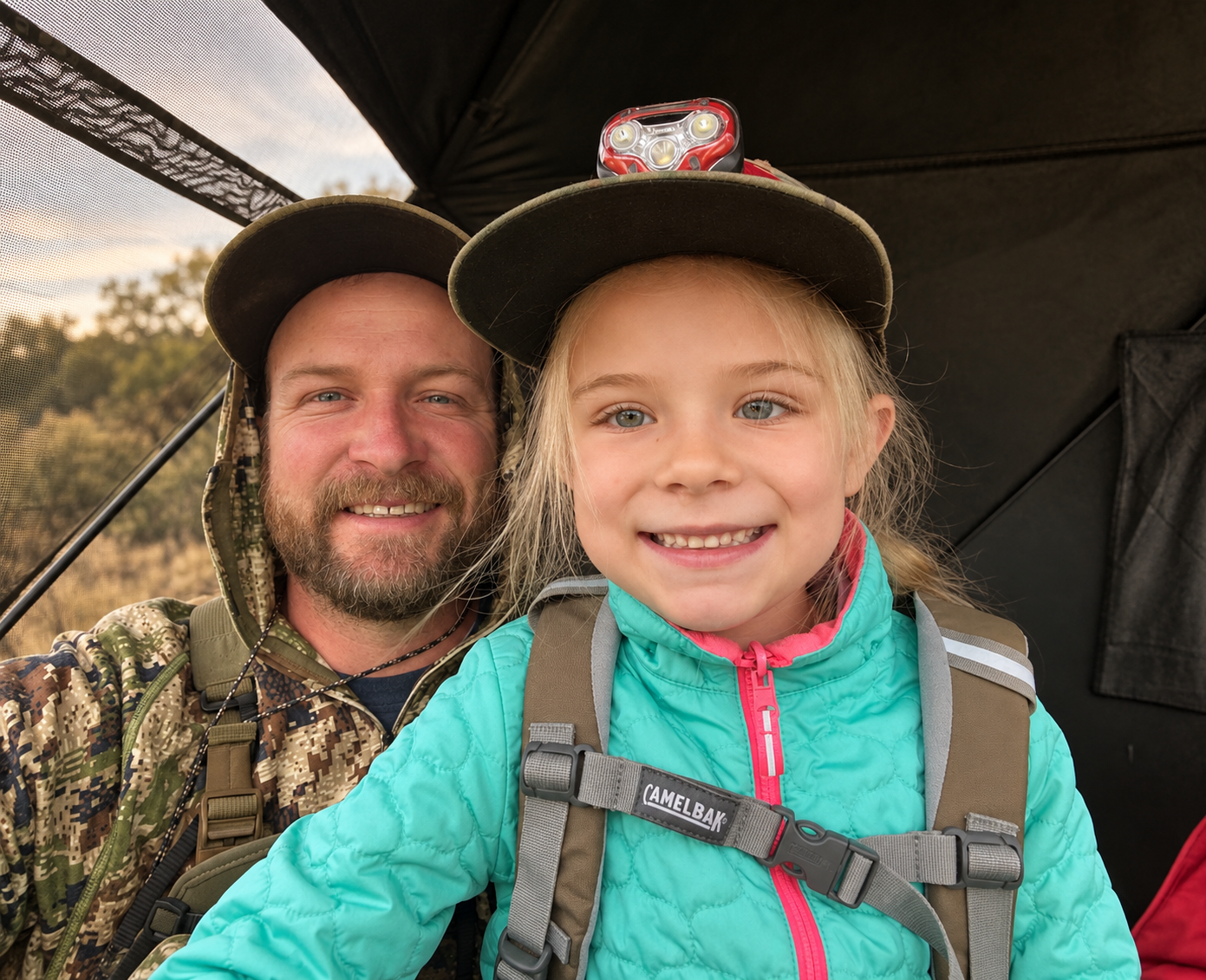 An adult and child spending time together in a hunting blind